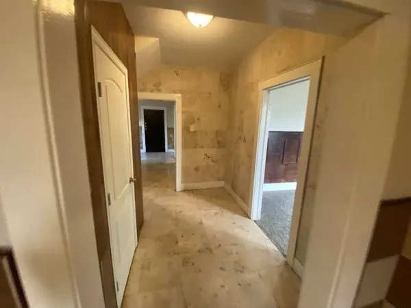 a view of a hallway with wooden shelves