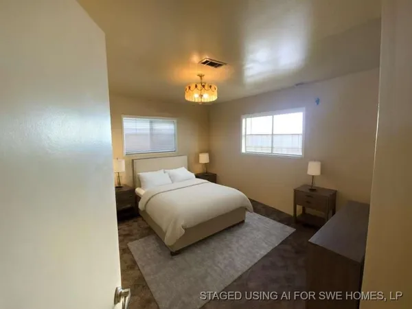 a bedroom with a bed and a lamp