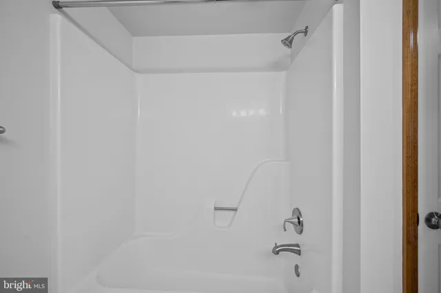 a bathroom with a granite countertop sink a toilet and shower