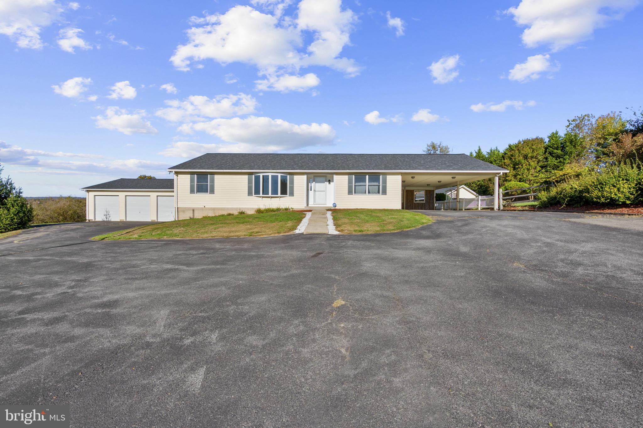 3226 Bidle Road Middletown, MD 21769 - Photo 2 of 49 a front view of a house with a garden and lake view
