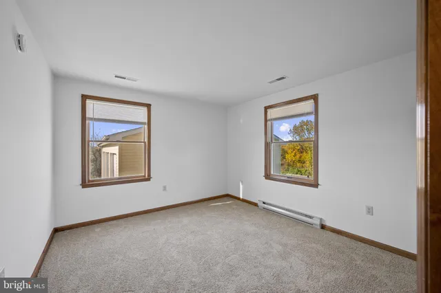 a view of empty room with wooden ceiling