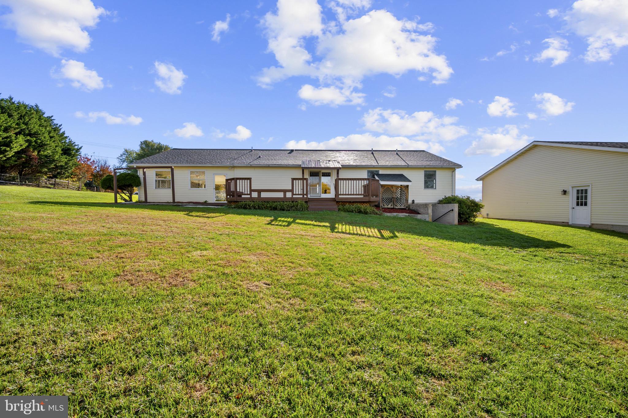 3226 Bidle Road Middletown, MD 21769 - Photo 40 of 49 a view of a big yard with table and chairs under an umbrella