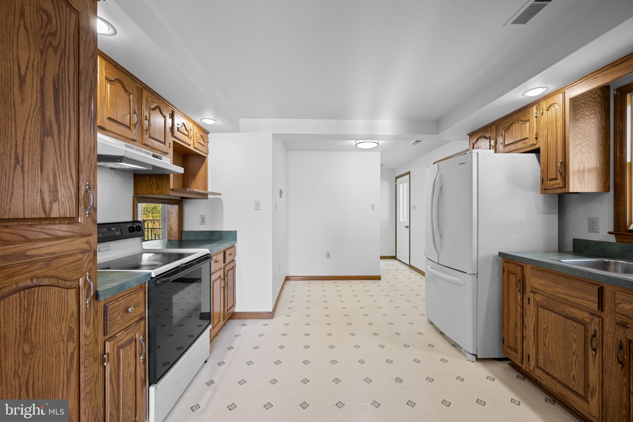 3226 Bidle Road Middletown, MD 21769 - Photo 8 of 49 a kitchen with stainless steel appliances granite countertop a sink stove and refrigerator