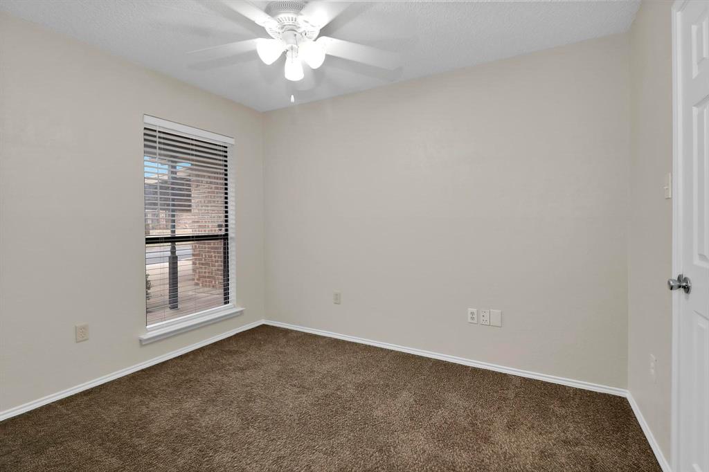 6632 Valley View Drive Watauga, TX 76148 - Photo 14 of 18 an empty room with a window and a fan