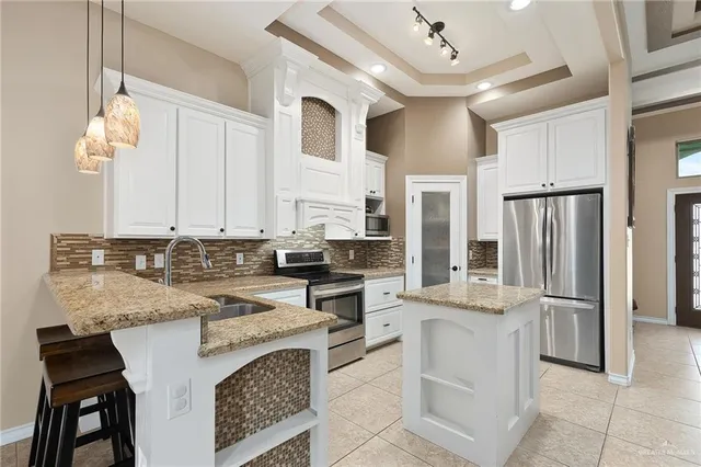 a kitchen with cabinets and refrigerator