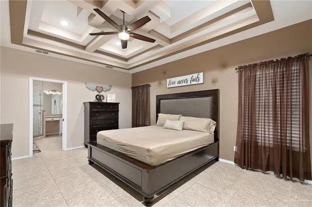 a large bed sitting in a bedroom next to a bathroom