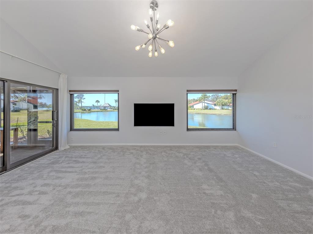 764 Sarabay Road, Unit 8 Osprey, FL 34229 - Photo 13 of 64 an empty room with windows and fireplace