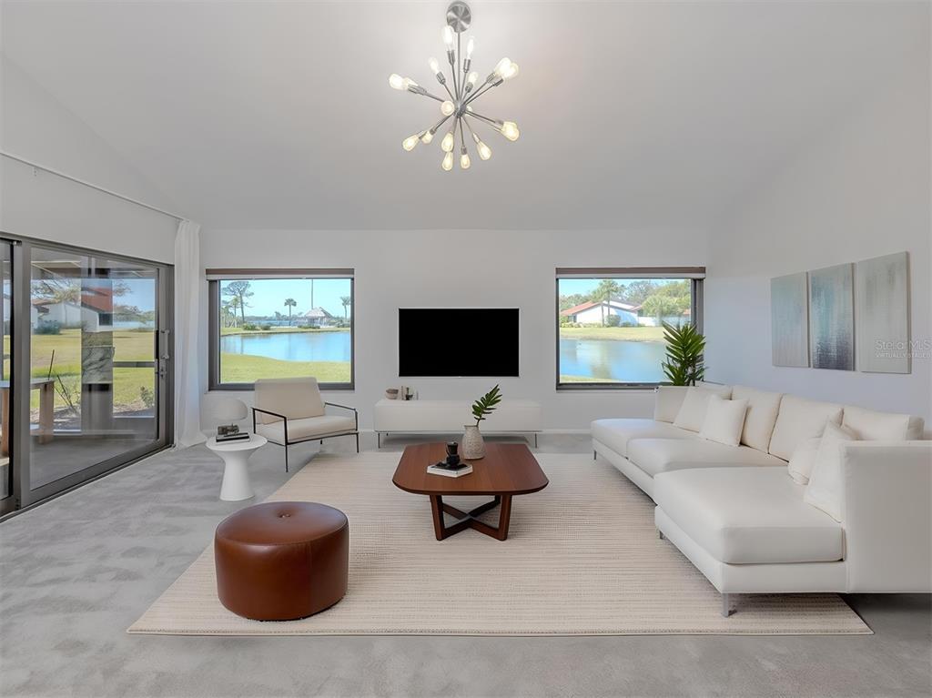 764 Sarabay Road, Unit 8 Osprey, FL 34229 - Photo 14 of 64 a living room with furniture and a flat screen tv
