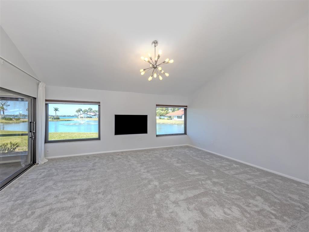 764 Sarabay Road, Unit 8 Osprey, FL 34229 - Photo 15 of 64 an empty room with windows and fireplace