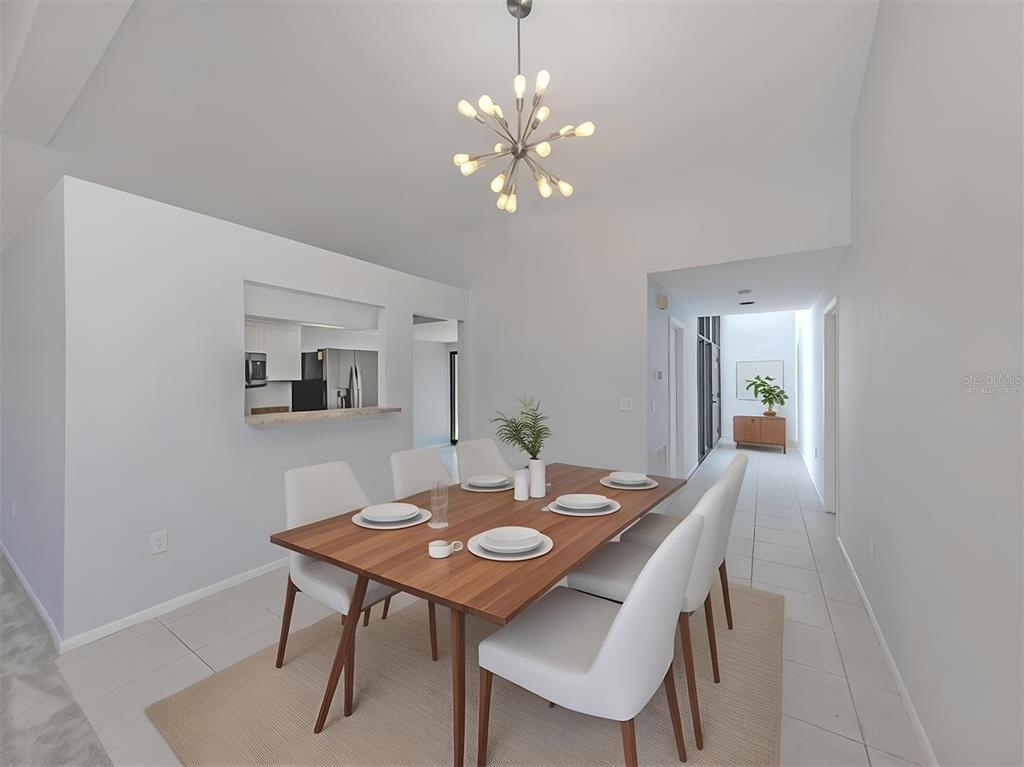 764 Sarabay Road, Unit 8 Osprey, FL 34229 - Photo 17 of 64 a view of a dining room with a table and chairs