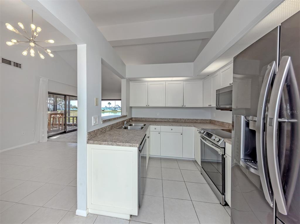 764 Sarabay Road, Unit 8 Osprey, FL 34229 - Photo 19 of 64 a kitchen with a stove sink and refrigerator