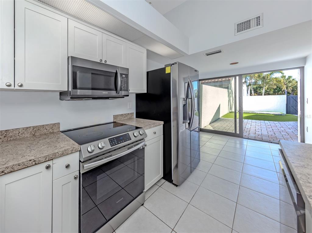 764 Sarabay Road, Unit 8 Osprey, FL 34229 - Photo 22 of 64 a kitchen with a stove a microwave and refrigerator