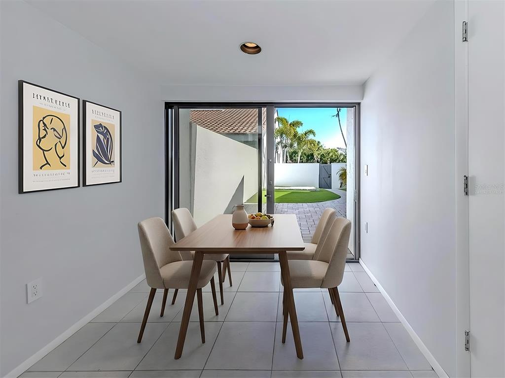 764 Sarabay Road, Unit 8 Osprey, FL 34229 - Photo 24 of 64 a view of a dining room with furniture window and outside view
