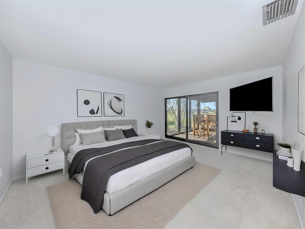 764 Sarabay Road, Unit 8 Osprey, FL 34229 - Photo 28 of 64 a spacious bedroom with a bed and a flat screen tv