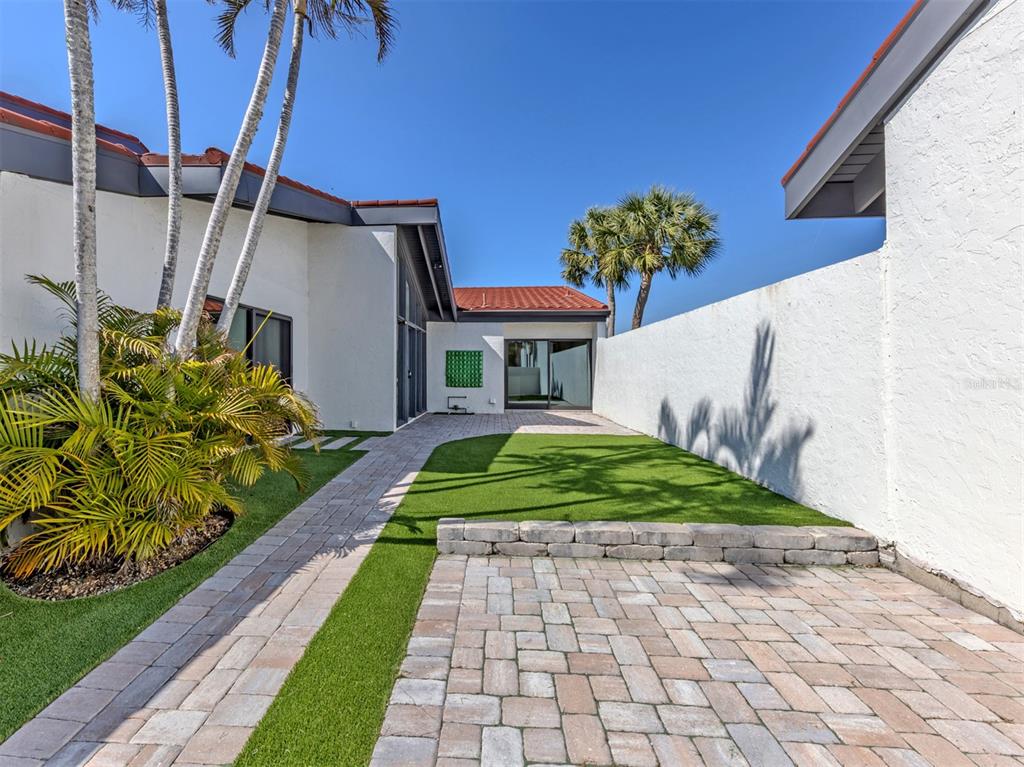 764 Sarabay Road, Unit 8 Osprey, FL 34229 - Photo 3 of 64 a front view of a house with garden