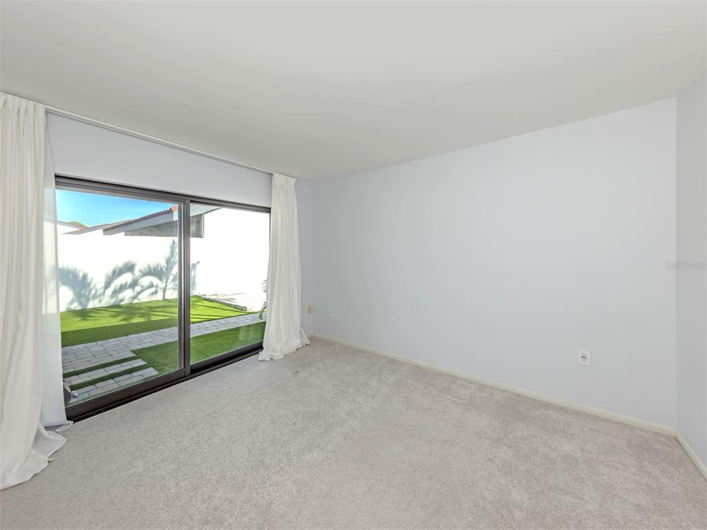 764 Sarabay Road, Unit 8 Osprey, FL 34229 - Photo 32 of 64 a view of an empty room with wooden floor and a balcony