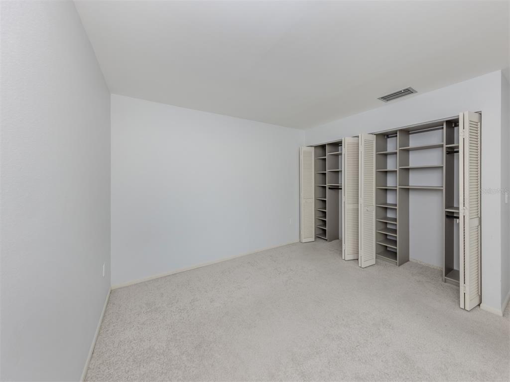 764 Sarabay Road, Unit 8 Osprey, FL 34229 - Photo 33 of 64 a view of an empty room with closet and racks