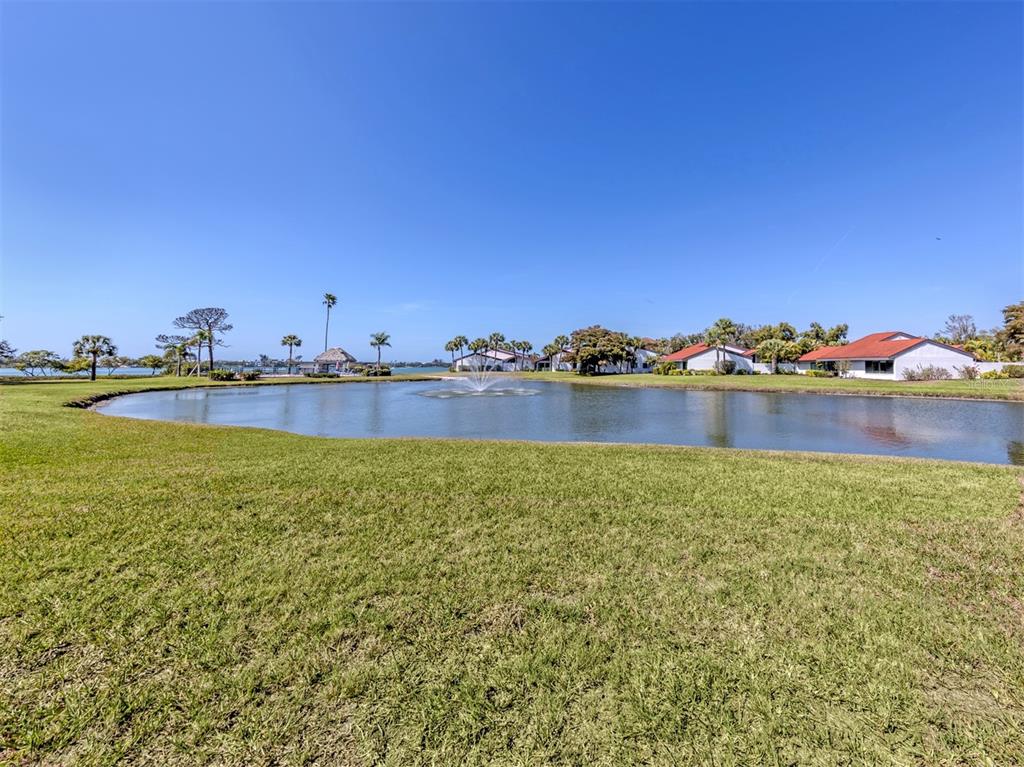 764 Sarabay Road, Unit 8 Osprey, FL 34229 - Photo 39 of 64 a view of a lake with boats and trees in the background