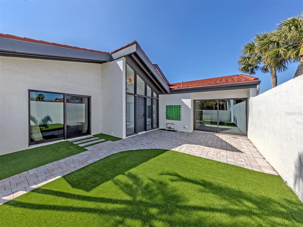 764 Sarabay Road, Unit 8 Osprey, FL 34229 - Photo 4 of 64 a view of an house with backyard porch and furniture