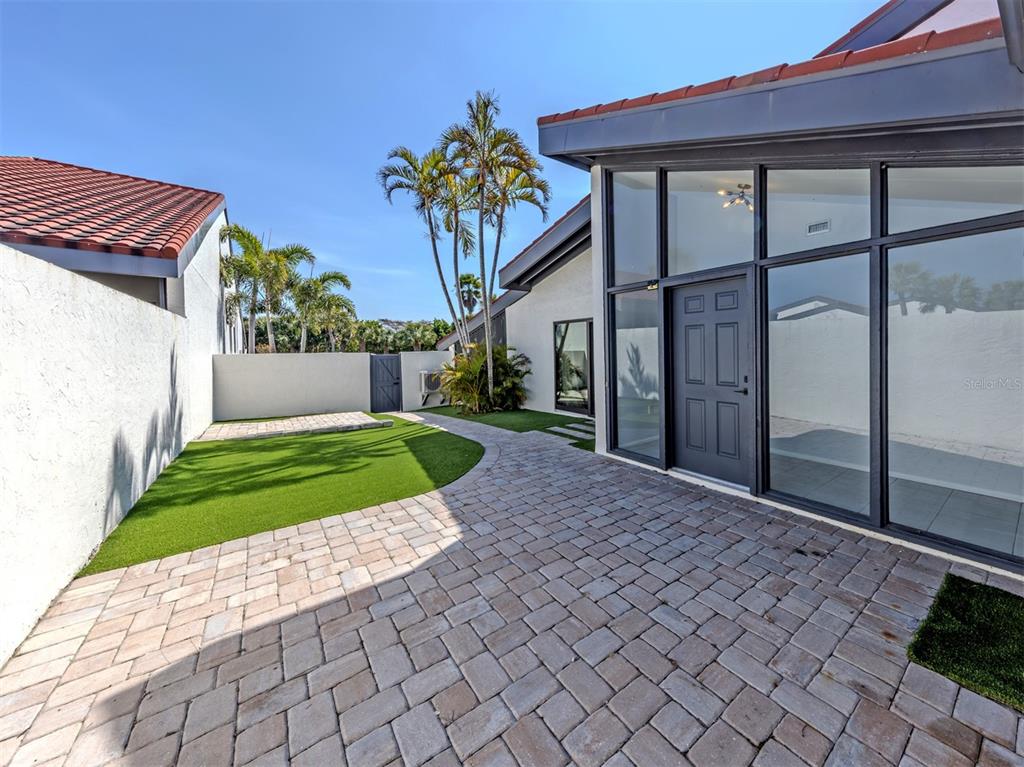 764 Sarabay Road, Unit 8 Osprey, FL 34229 - Photo 5 of 64 a front view of a house with a yard and garage