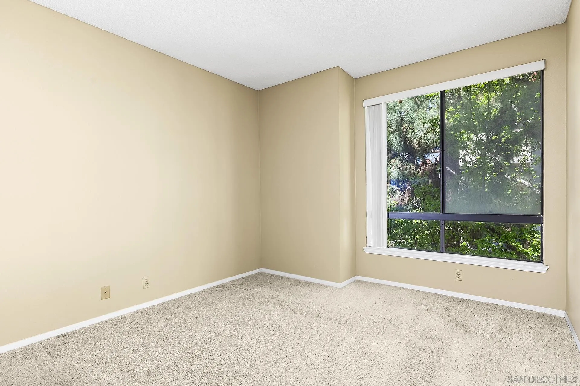 5875 Friars Road, Unit 4307 San Diego, CA 92110 - Photo 12 of 26 an empty room with wooden floor and a window