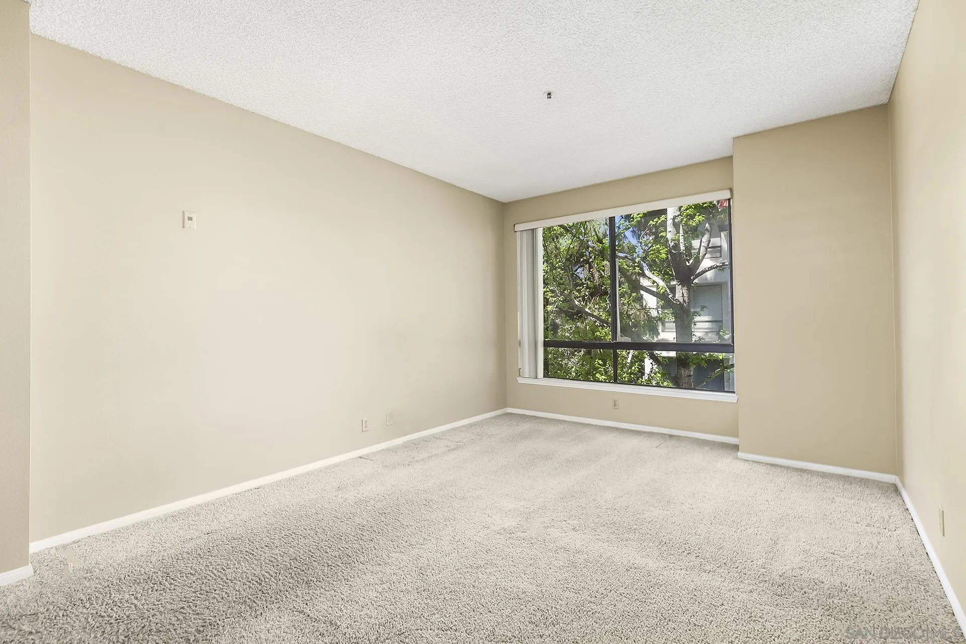 5875 Friars Road, Unit 4307 San Diego, CA 92110 - Photo 17 of 26 an empty room with large windows