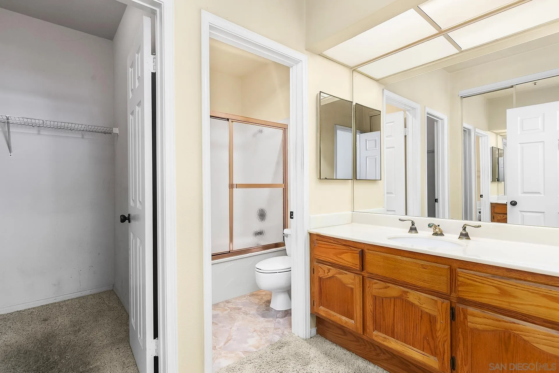5875 Friars Road, Unit 4307 San Diego, CA 92110 - Photo 18 of 26 a bathroom with a double vanity sink toilet mirror and bathtub