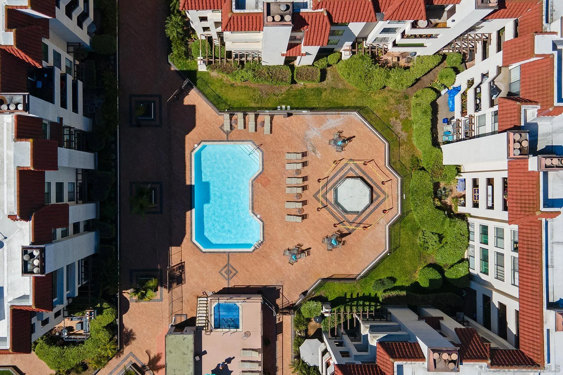 5875 Friars Road, Unit 4307 San Diego, CA 92110 - Photo 21 of 26 an aerial view of a residential apartment building with a yard and outdoor seating