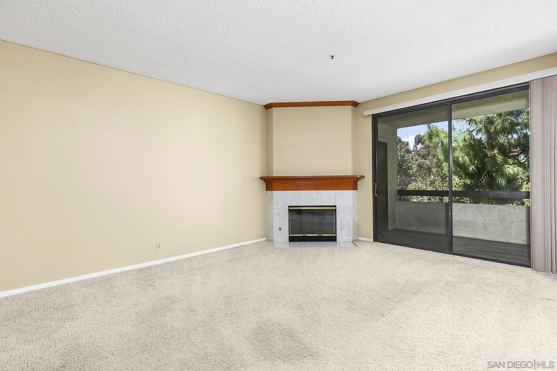 5875 Friars Road, Unit 4307 San Diego, CA 92110 - Photo 4 of 26 a view of an empty room with a fireplace and a window
