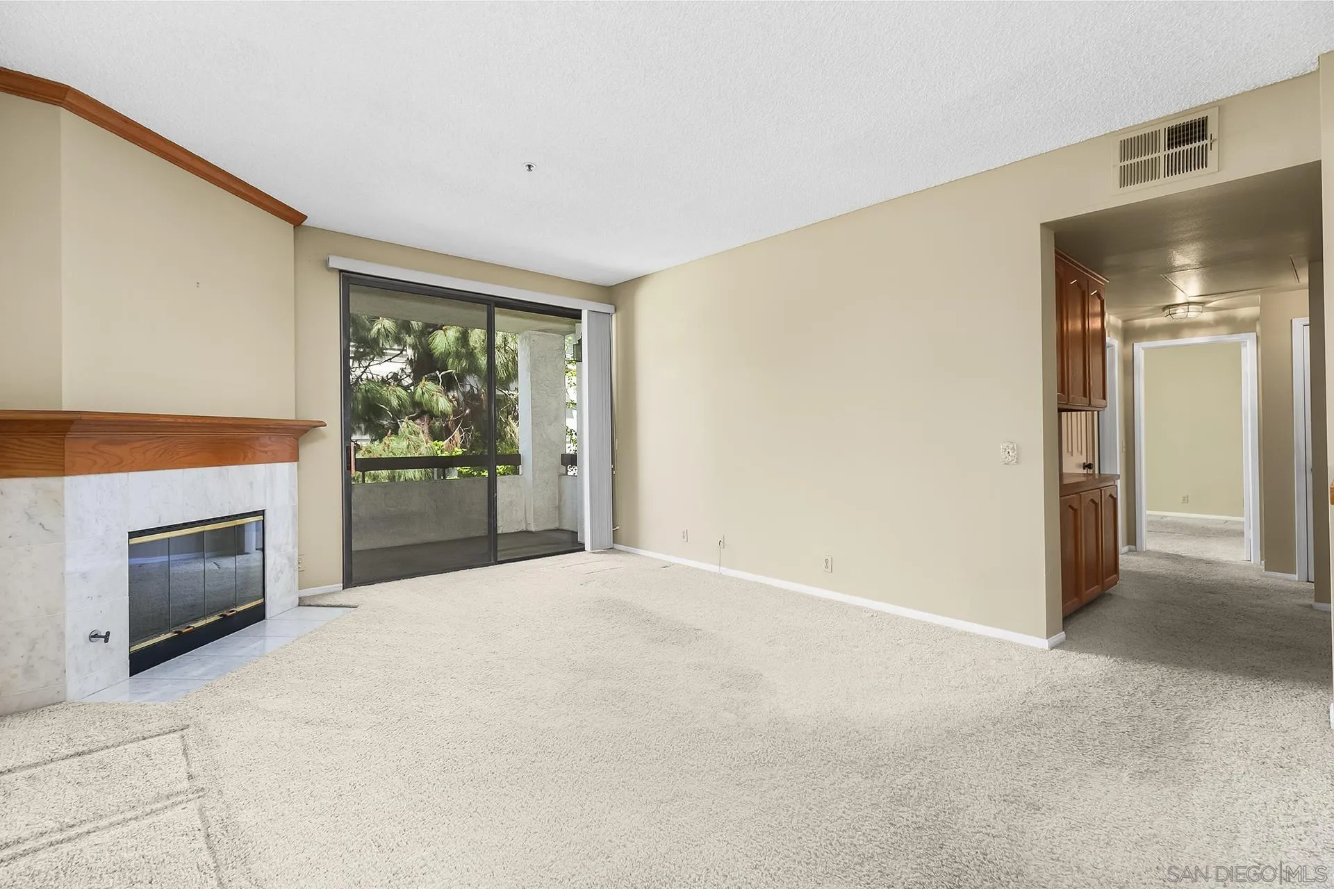 5875 Friars Road, Unit 4307 San Diego, CA 92110 - Photo 5 of 26 a view of an empty room with a fireplace and a window