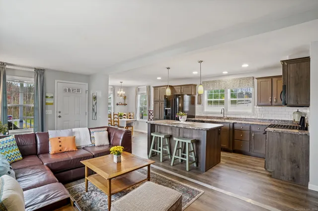 a view of kitchen with stainless steel appliances granite countertop lots of counter top space