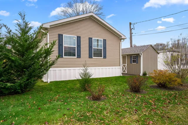 a view of a house with a yard and plants