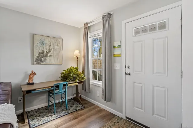 a dining room with furniture and window