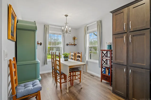 a view of a dining room with furniture window and wooden floor