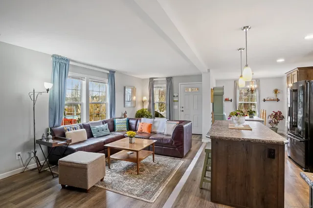 a living room with furniture and a chandelier
