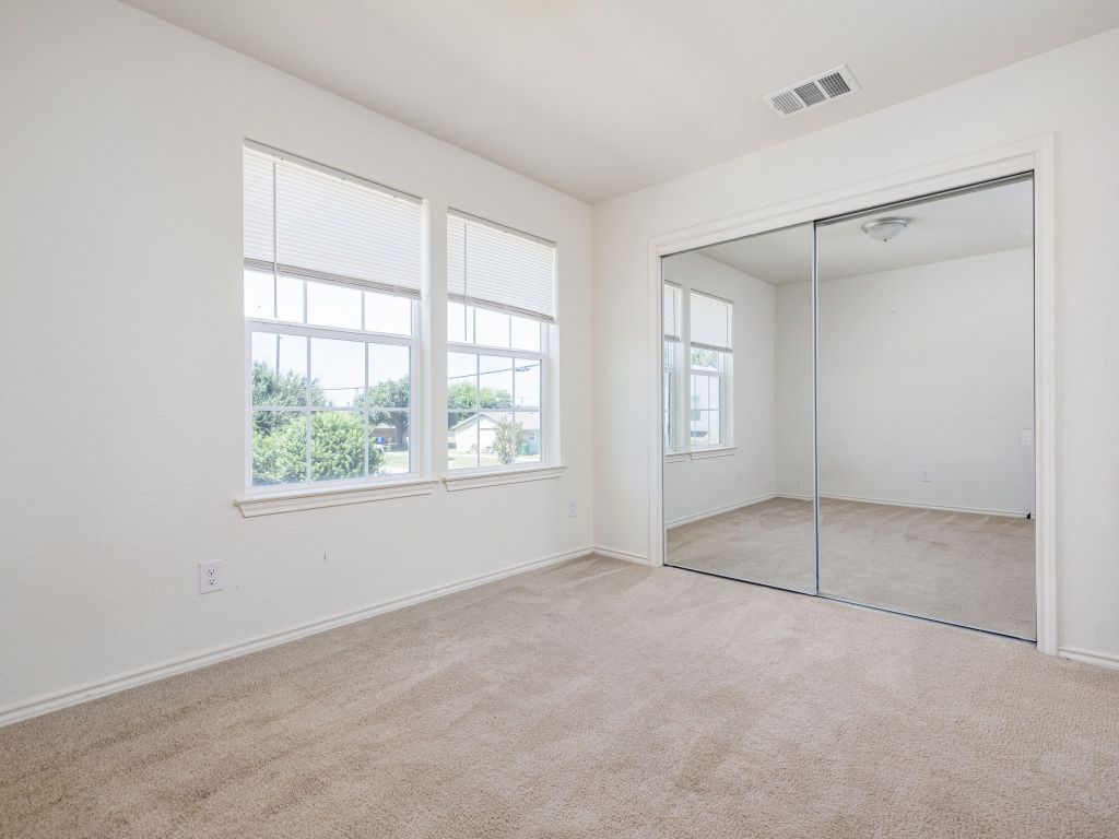 230 Debus Drive, Unit 101 Taylor, TX 76574 - Photo 11 of 17 an empty room with windows and closet