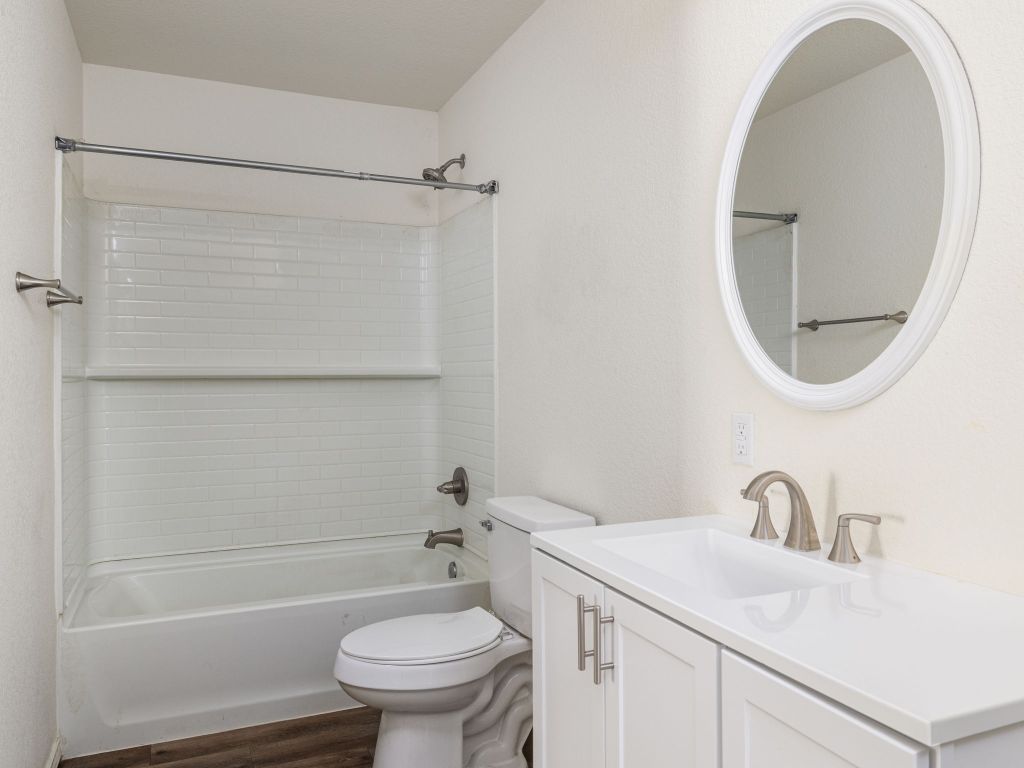 230 Debus Drive, Unit 101 Taylor, TX 76574 - Photo 12 of 17 a bathroom with a sink a toilet and a mirror