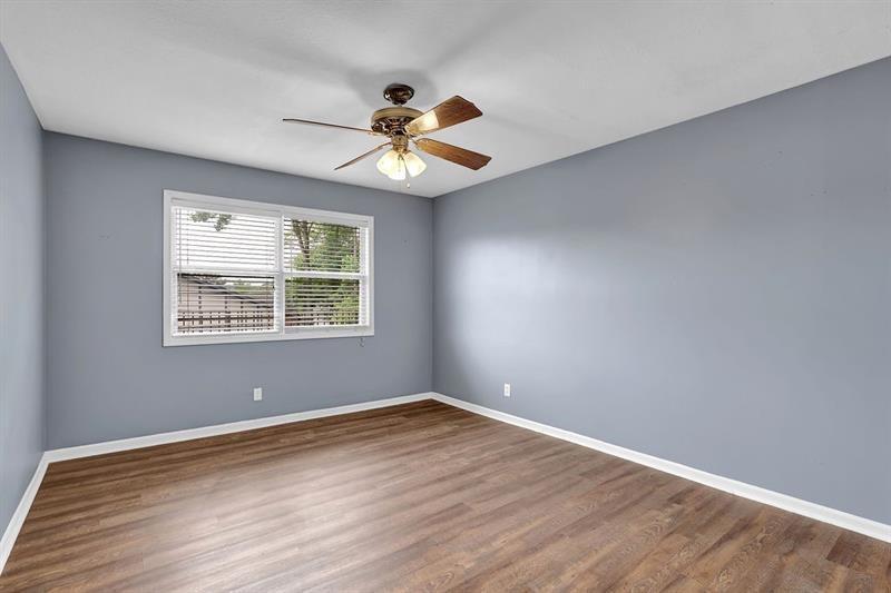 6851 Roswell Road, Unit C7 Atlanta, GA 30328 - Photo 13 of 28 a view of an empty room with window and wooden floor