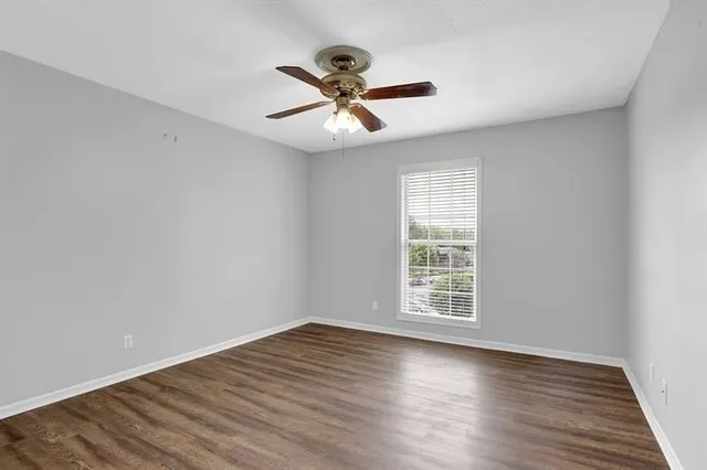wooden floor in an empty room with a window