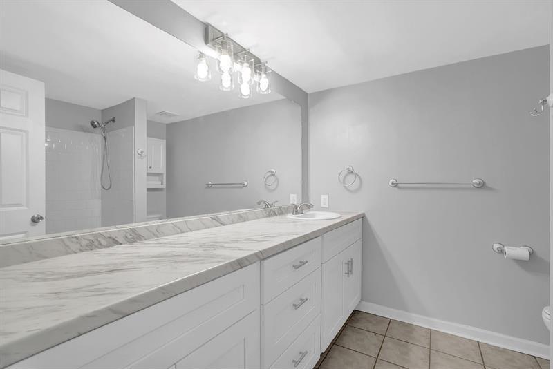 6851 Roswell Road, Unit C7 Atlanta, GA 30328 - Photo 15 of 28 a spacious bathroom with a sink and a mirror