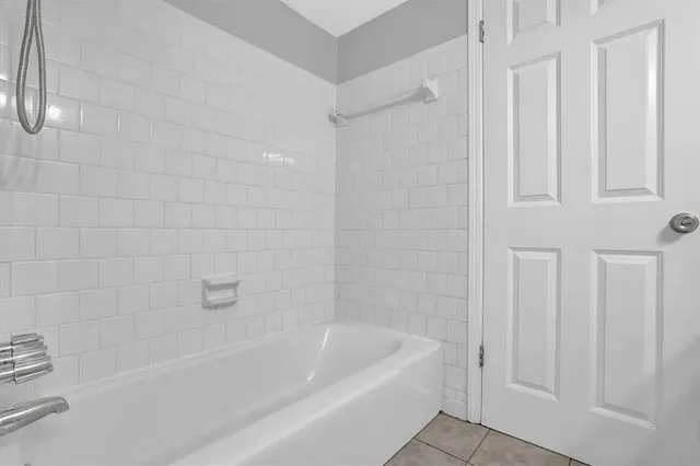 a bathroom with bathtub and shower