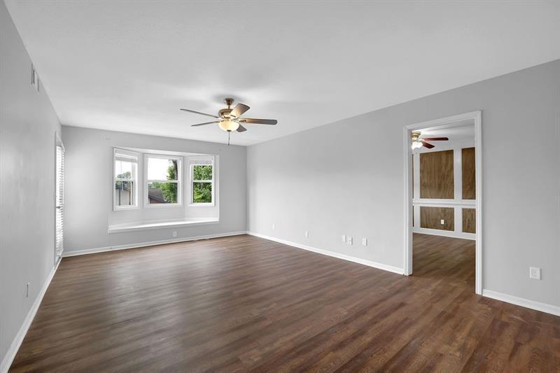 6851 Roswell Road, Unit C7 Atlanta, GA 30328 - Photo 2 of 28 a view of an empty room with wooden floor and a window