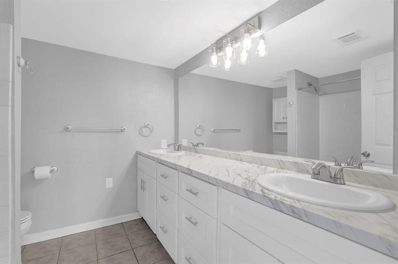 6851 Roswell Road, Unit C7 Atlanta, GA 30328 - Photo 21 of 28 a bathroom with a granite countertop sink and a mirror