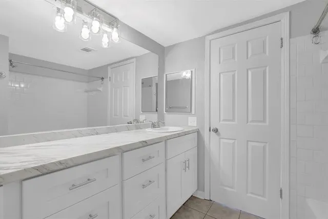 a bathroom with a double vanity sink and a mirror