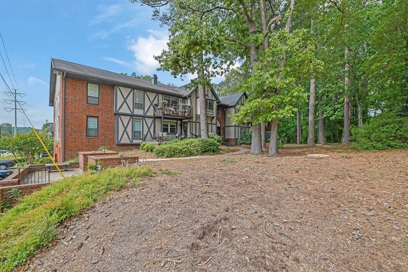 6851 Roswell Road, Unit C7 Atlanta, GA 30328 - Photo 26 of 28 a front view of a house with garden