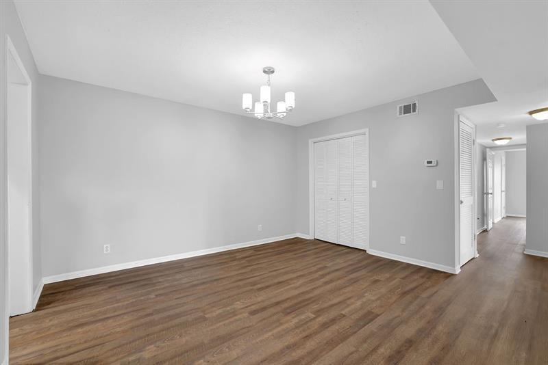 6851 Roswell Road, Unit C7 Atlanta, GA 30328 - Photo 7 of 28 a view of an empty room with wooden floor