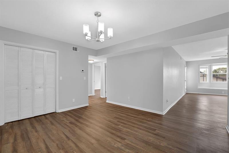 6851 Roswell Road, Unit C7 Atlanta, GA 30328 - Photo 9 of 28 a view of an empty room with wooden floor