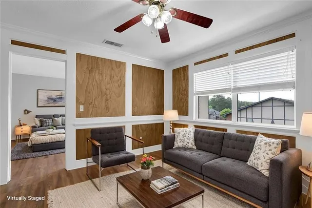 a living room with furniture and a large window