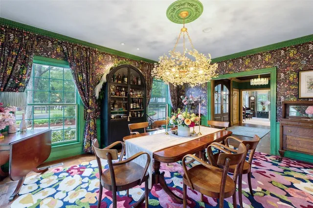 a view of a dining room with furniture and chandelier