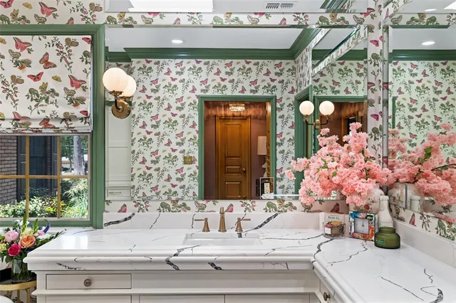 a bathroom with a sink mirror and vanity